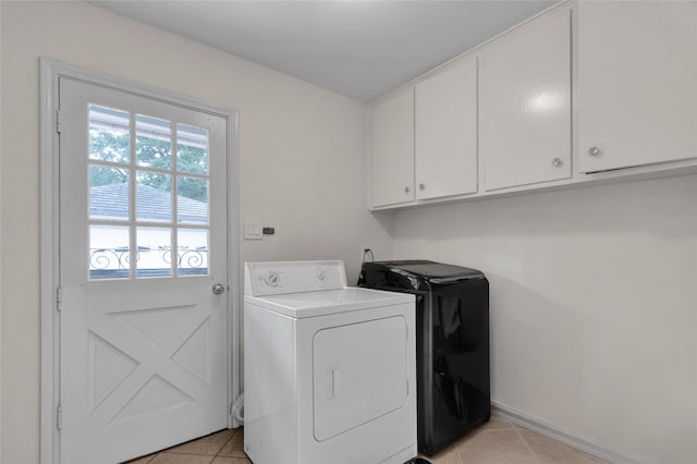 2010 Oceanview Dr, Seabrook, TX 77586 - washroom with washing machine and clothes dryer, cabinet space, and light tile patterned floors