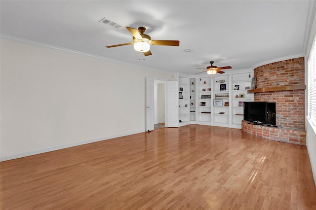 2010 Oceanview Dr, Seabrook, TX 77586 - unfurnished living room with ceiling fan, light wood finished floors, crown molding, a brick fireplace, and built in features