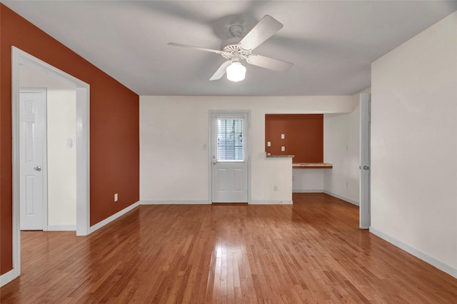 2010 Oceanview Dr, Seabrook, TX 77586 - unfurnished living room featuring light wood-style flooring and a ceiling fan