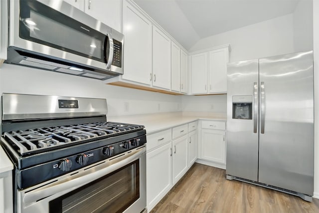 2921 Eden Lake Ln, Katy, TX 77493 - kitchen featuring stainless steel appliances, light countertops, white cabinetry, and light wood-type flooring