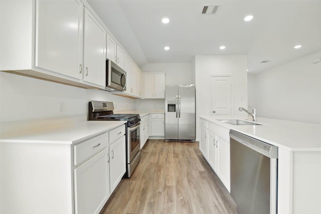 2921 Eden Lake Ln, Katy, TX 77493 - kitchen with appliances with stainless steel finishes, light wood-style flooring, white cabinets, light countertops, and recessed lighting