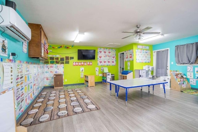 402 W Converse St, Weimar, TX 78962 - game room featuring a wall mounted air conditioner, wood finished floors, and a ceiling fan
