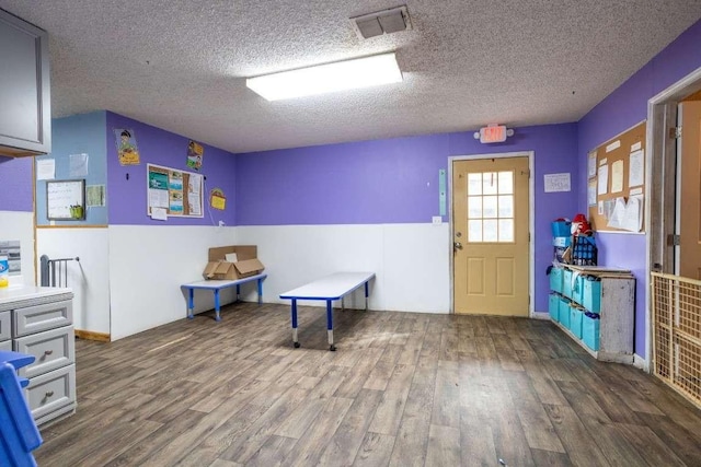 402 W Converse St, Weimar, TX 78962 - game room with wood finished floors and a textured ceiling
