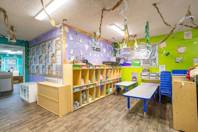 402 W Converse St, Weimar, TX 78962 - playroom featuring a textured ceiling and wood finished floors