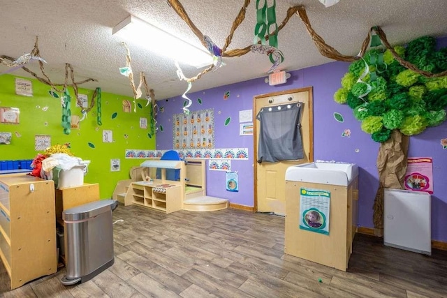 402 W Converse St, Weimar, TX 78962 - recreation room with a textured ceiling and wood finished floors