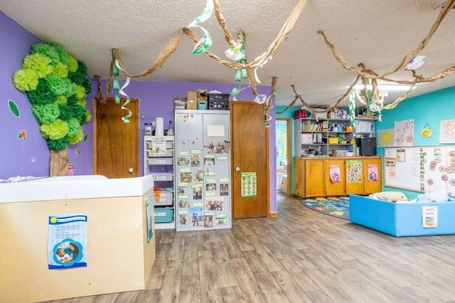 402 W Converse St, Weimar, TX 78962 - recreation room featuring a textured ceiling and wood finished floors