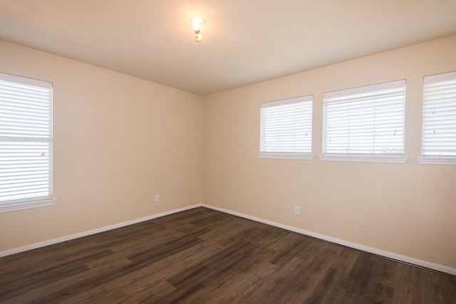 8603 E Windhaven Terrace Trl, Cypress, TX 77433 - unfurnished room featuring dark wood-style floors and baseboards