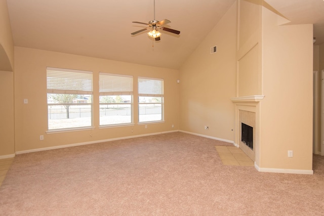 8603 E Windhaven Terrace Trl, Cypress, TX 77433 - unfurnished living room with light carpet, plenty of natural light, ceiling fan, a tile fireplace, and high vaulted ceiling