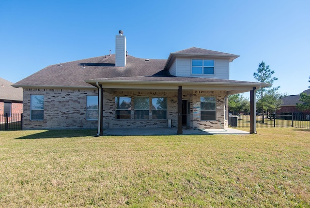 8603 E Windhaven Terrace Trl, Cypress, TX 77433 - rear view of house featuring a patio, brick siding, and a chimney