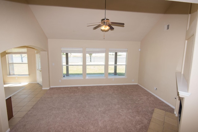 8603 E Windhaven Terrace Trl, Cypress, TX 77433 - unfurnished living room featuring vaulted ceiling, a ceiling fan, arched walkways, and plenty of natural light