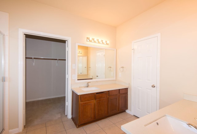8603 E Windhaven Terrace Trl, Cypress, TX 77433 - bathroom with vanity, tile patterned floors, a shower with shower door, and a spacious closet