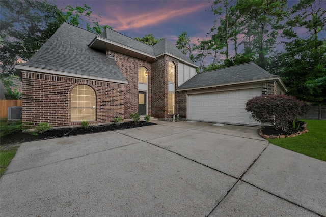 4327 Long Glen Dr, Houston, TX 77339 - view of front of home featuring driveway, brick siding, roof with shingles, and a garage
