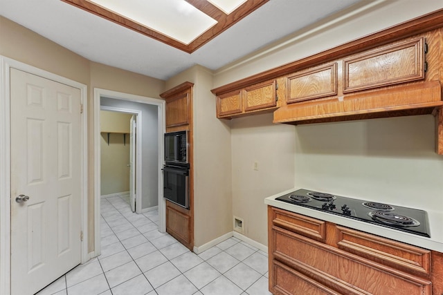 4327 Long Glen Dr, Houston, TX 77339 - kitchen featuring black appliances, brown cabinets, light tile patterned flooring, and light countertops