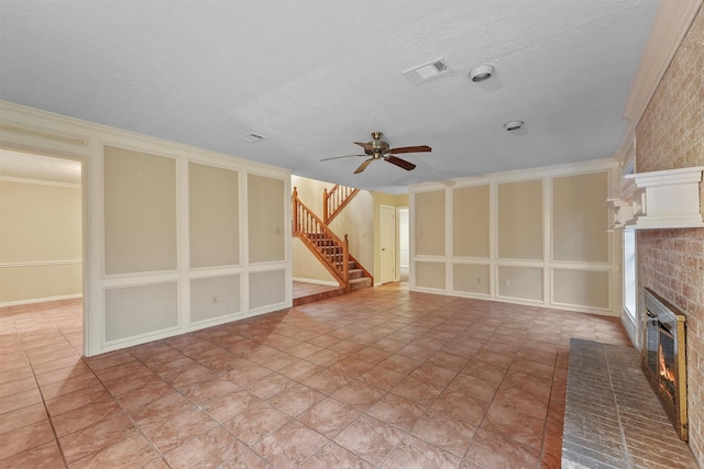 4327 Long Glen Dr, Houston, TX 77339 - unfurnished living room featuring a brick fireplace, a ceiling fan, and stairs