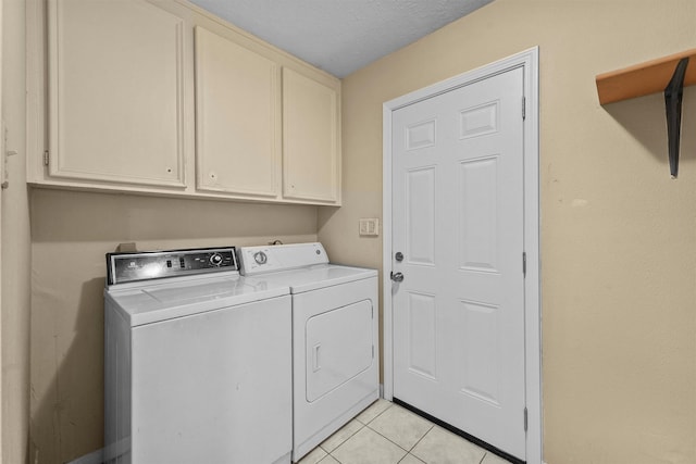 4327 Long Glen Dr, Houston, TX 77339 - laundry room featuring washer and dryer, cabinet space, and light tile patterned floors
