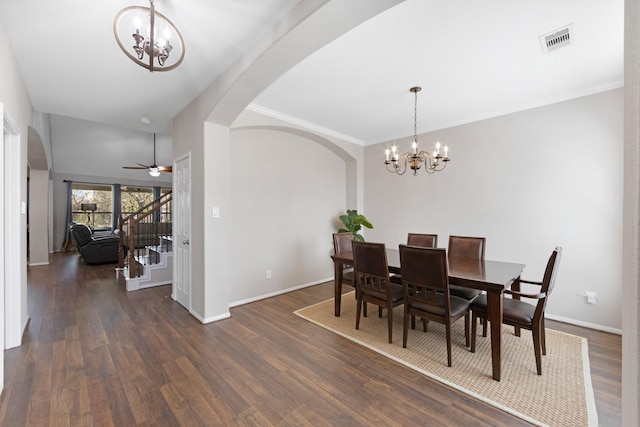 19610 Blushing Meadow Dr, Cypress, TX 77433 - dining room with arched walkways, a chandelier, stairs, dark wood-type flooring, and a ceiling fan