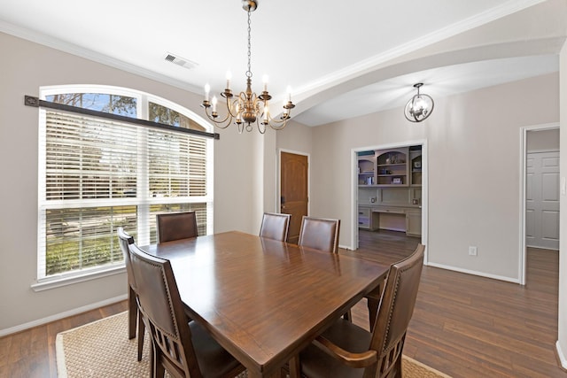 19610 Blushing Meadow Dr, Cypress, TX 77433 - dining room with a chandelier, wood finished floors, arched walkways, and crown molding