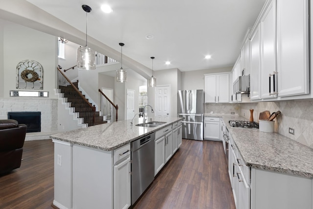 19610 Blushing Meadow Dr, Cypress, TX 77433 - kitchen with stainless steel appliances, dark wood-type flooring, white cabinetry, open floor plan, and wall chimney range hood