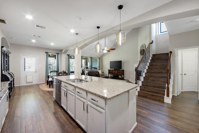 19610 Blushing Meadow Dr, Cypress, TX 77433 - kitchen with a ceiling fan, stainless steel dishwasher, dark wood-style floors, light stone counters, and plenty of natural light