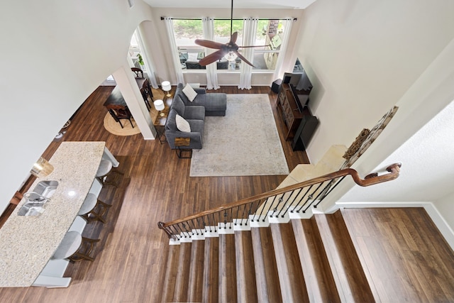 19610 Blushing Meadow Dr, Cypress, TX 77433 - living room with wood finished floors, arched walkways, a ceiling fan, and stairs