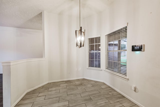622 Magnolia Bend St, League City, TX 77573 - unfurnished dining area with wood tiled floors and a chandelier