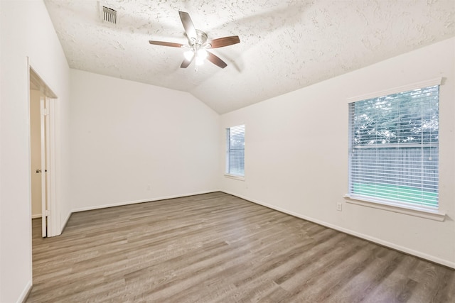 622 Magnolia Bend St, League City, TX 77573 - empty room with a textured ceiling, wood finished floors, a ceiling fan, and lofted ceiling