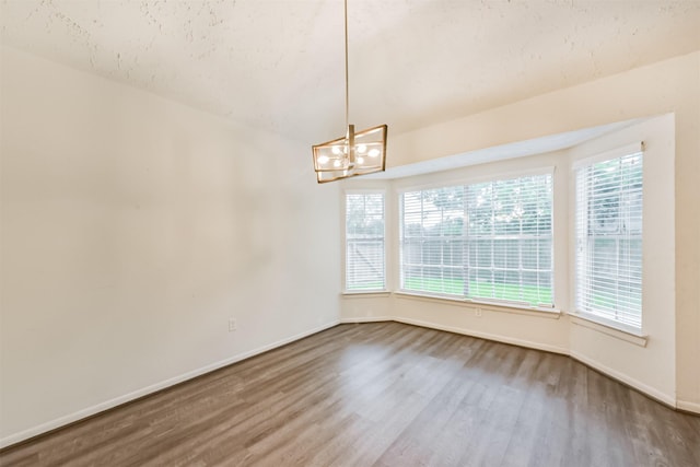 622 Magnolia Bend St, League City, TX 77573 - empty room with wood finished floors and a chandelier