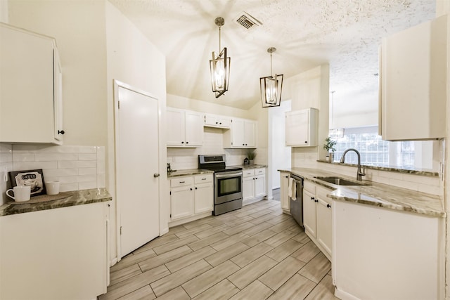 622 Magnolia Bend St, League City, TX 77573 - kitchen with appliances with stainless steel finishes, decorative backsplash, white cabinets, light stone counters, and a textured ceiling