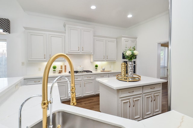 25619 Tower Side Ln, Katy, TX 77494 - kitchen featuring light countertops, white cabinets, ornamental molding, recessed lighting, and dark wood-type flooring