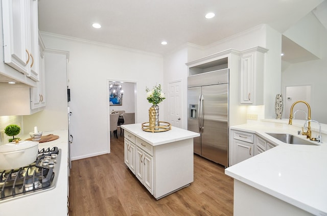 25619 Tower Side Ln, Katy, TX 77494 - kitchen with appliances with stainless steel finishes, ornamental molding, open shelves, light wood-style flooring, and light countertops