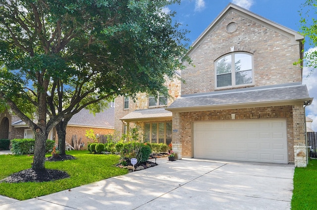 25619 Tower Side Ln, Katy, TX 77494 - view of front of property featuring a garage, a front lawn, driveway, and brick siding
