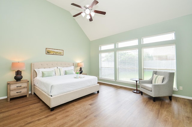 25619 Tower Side Ln, Katy, TX 77494 - bedroom with high vaulted ceiling, wood finished floors, and a ceiling fan