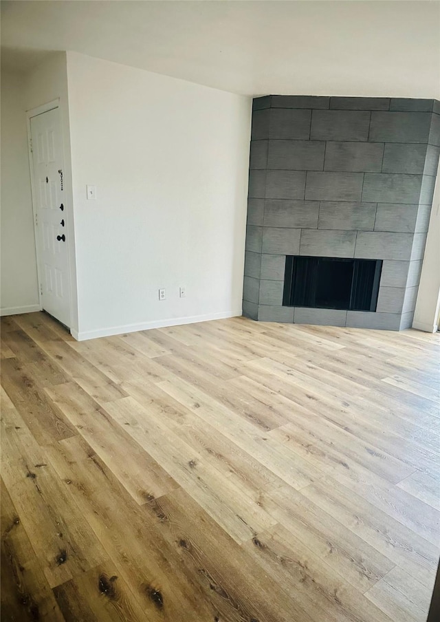 9350 Country Creek Dr Unit 58, Houston, TX 77036 - unfurnished living room with wood finished floors and a tile fireplace