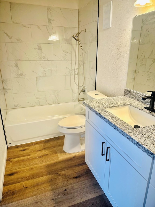 9350 Country Creek Dr Unit 58, Houston, TX 77036 - full bath with vanity, wood finished floors, bathing tub / shower combination, and a textured wall