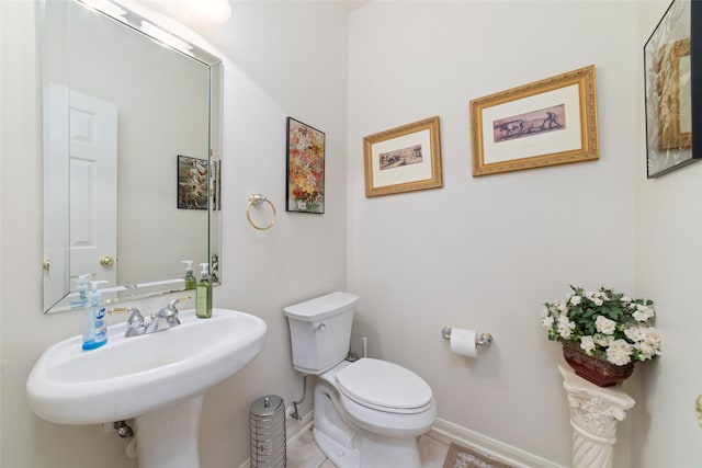 7311 Open Oak Way, Humble, TX 77346 - half bathroom with baseboards and tile patterned floors