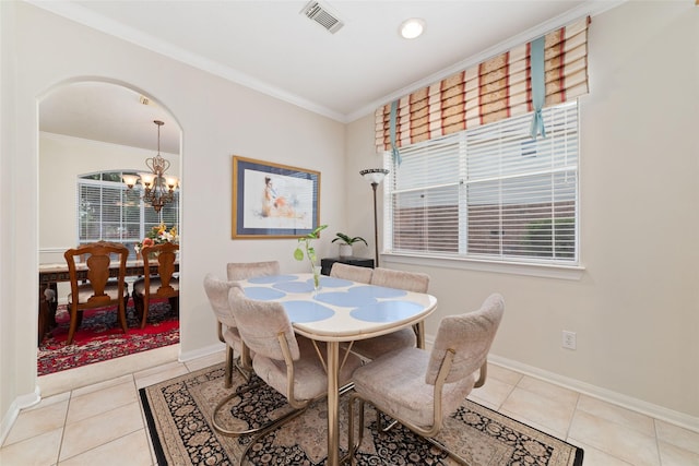 7311 Open Oak Way, Humble, TX 77346 - tiled dining area featuring a chandelier, ornamental molding, and arched walkways