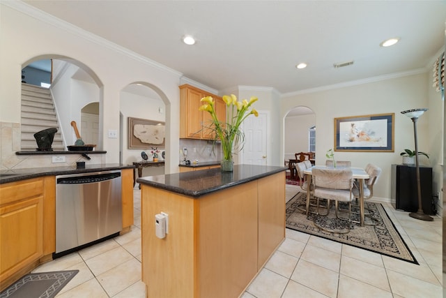 7311 Open Oak Way, Humble, TX 77346 - kitchen with dishwasher, backsplash, arched walkways, light tile patterned floors, and ornamental molding