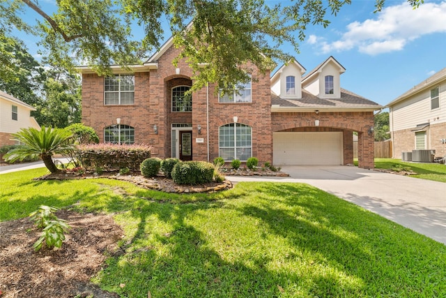 7311 Open Oak Way, Humble, TX 77346 - traditional home with brick siding, concrete driveway, and a front yard