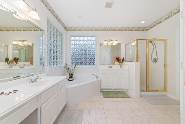 7311 Open Oak Way, Humble, TX 77346 - full bathroom with a stall shower, a bath, two vanities, and tile patterned floors