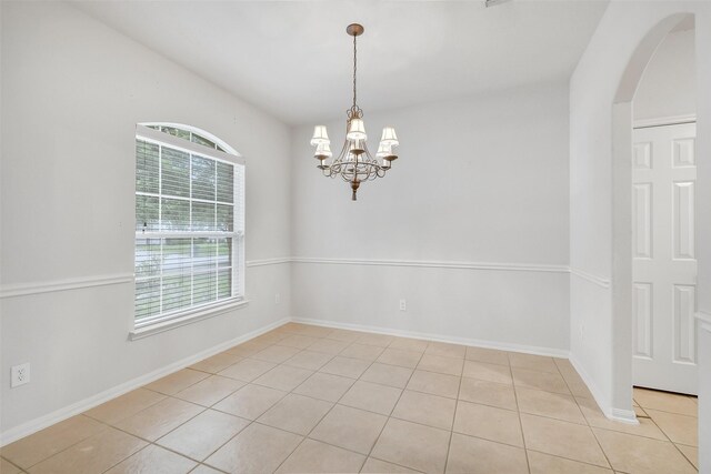 31 S Creekmist Pl, Conroe, TX 77385 - spare room with arched walkways, light tile patterned floors, and a chandelier