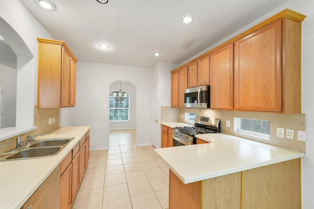 31 S Creekmist Pl, Conroe, TX 77385 - kitchen featuring stainless steel appliances, arched walkways, light countertops, decorative backsplash, and recessed lighting