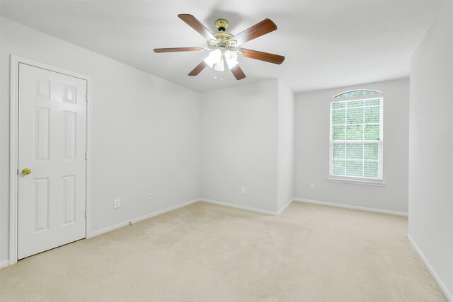 31 S Creekmist Pl, Conroe, TX 77385 - spare room featuring light carpet and a ceiling fan