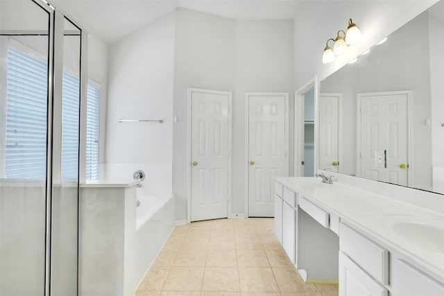 31 S Creekmist Pl, Conroe, TX 77385 - full bathroom with a bath, double vanity, tile patterned flooring, and a high ceiling