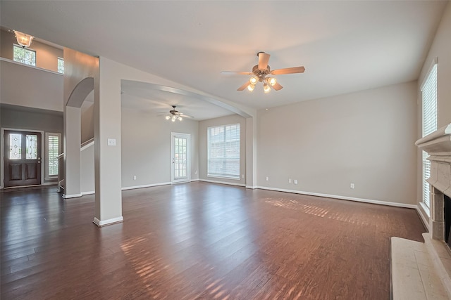 19819 Sternwood Manor Dr, Spring, TX 77379 - unfurnished living room featuring a ceiling fan, plenty of natural light, a fireplace with flush hearth, and dark wood finished floors