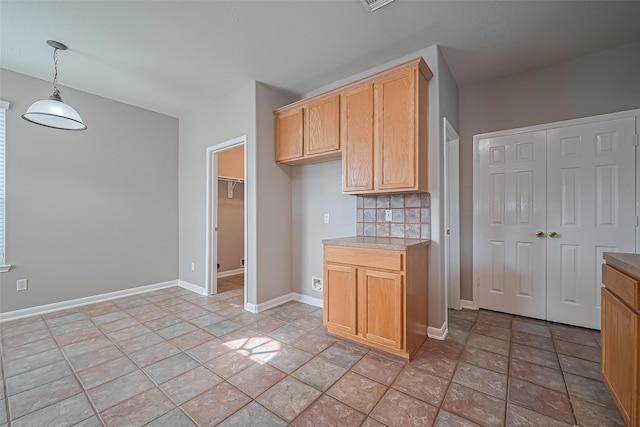 19819 Sternwood Manor Dr, Spring, TX 77379 - kitchen with backsplash, light stone finish flooring, decorative light fixtures, and light countertops