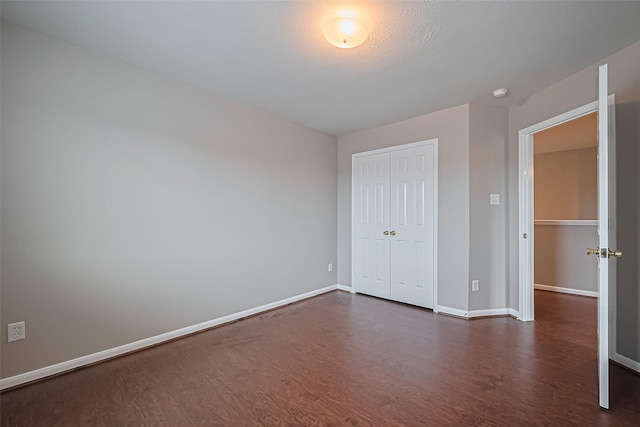 19819 Sternwood Manor Dr, Spring, TX 77379 - unfurnished bedroom featuring dark wood-style floors and a closet