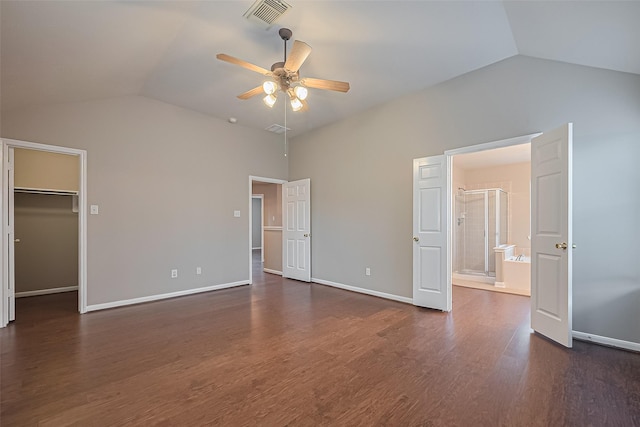19819 Sternwood Manor Dr, Spring, TX 77379 - unfurnished bedroom featuring vaulted ceiling, a walk in closet, dark wood-style flooring, ensuite bath, and ceiling fan