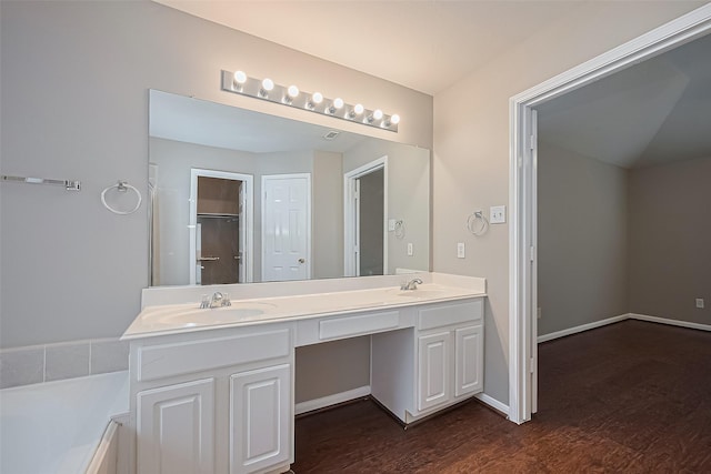 19819 Sternwood Manor Dr, Spring, TX 77379 - full bathroom with double vanity, wood finished floors, a tub to relax in, and a closet