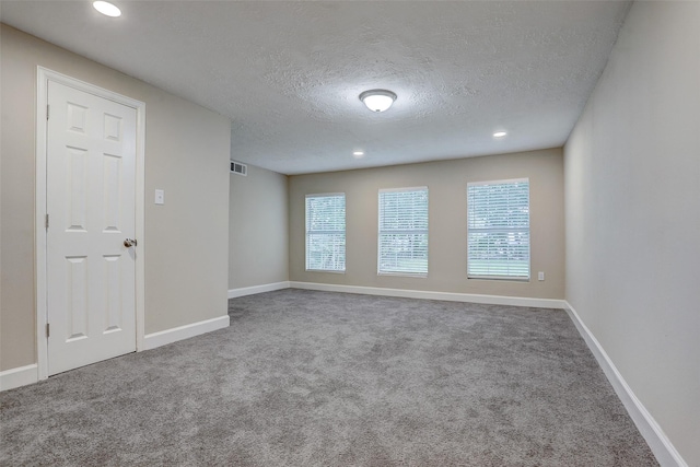 515 Main St, Pasadena, TX 77506 - carpeted empty room featuring a textured ceiling and recessed lighting