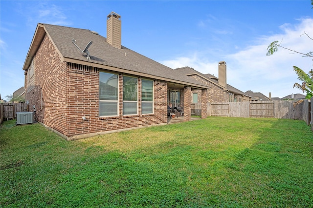 4831 Sunset Park Ln, Rosharon, TX 77583 - rear view of property featuring brick siding, a fenced backyard, a chimney, and roof with shingles